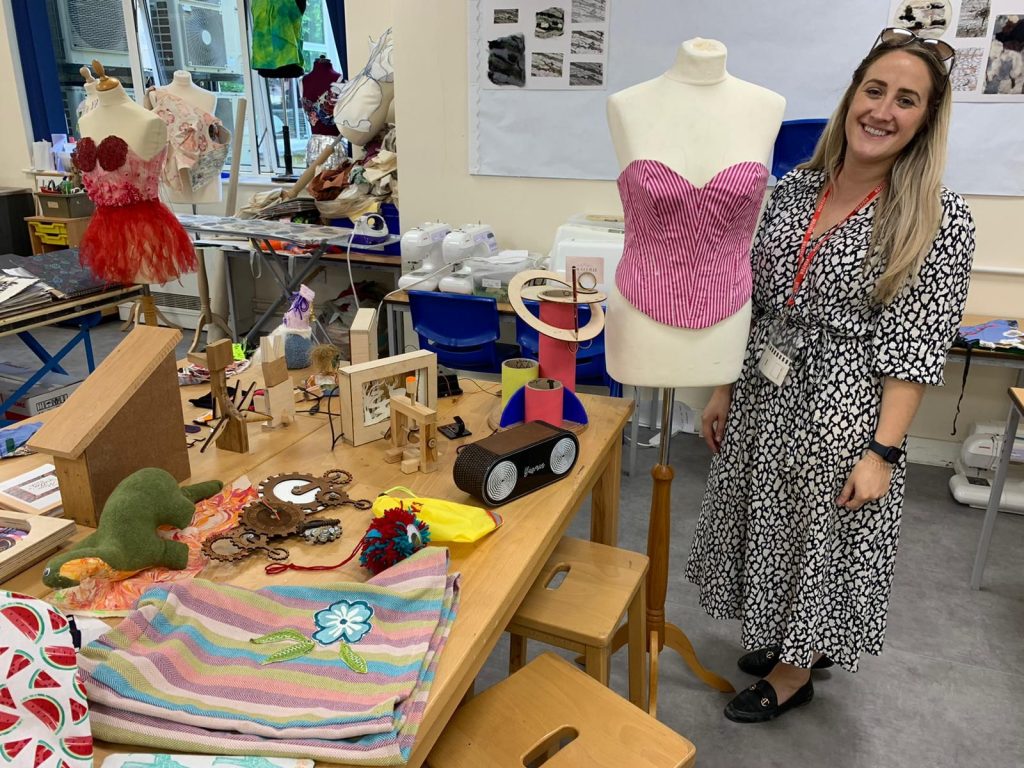 Design Technology trainee Yasmin showcasing something she made from learning new skills in textiles